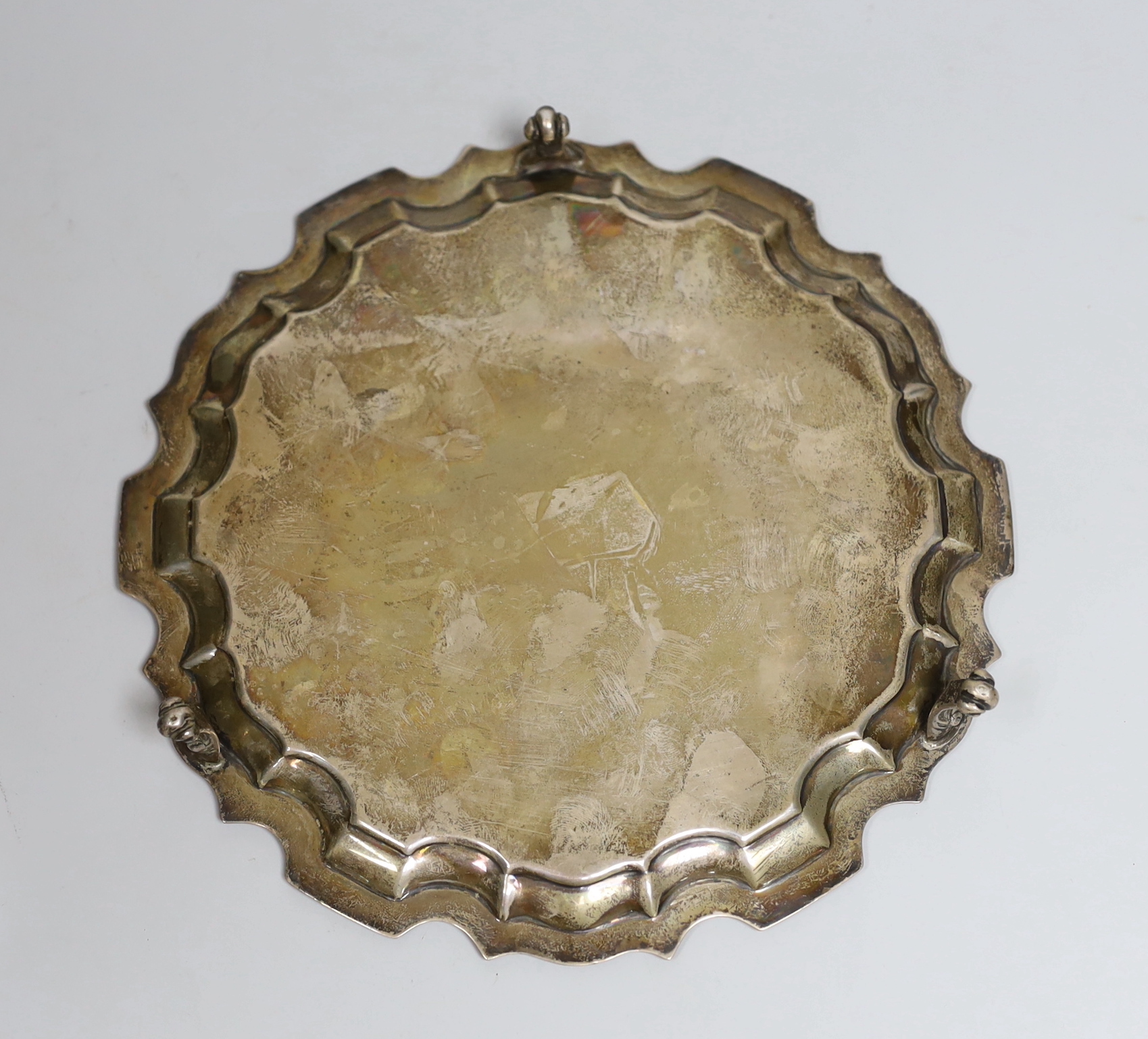 An Edwardian silver waiter, with pie crust border, on three scroll feet, Daniel George Collins, Sheffield, 1909, 21cm, 10.3oz.